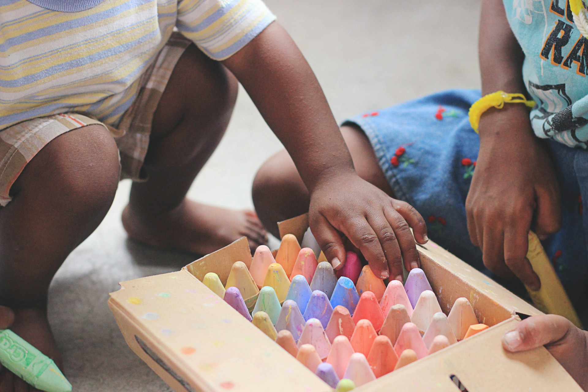 kids opening a box of paint supplies